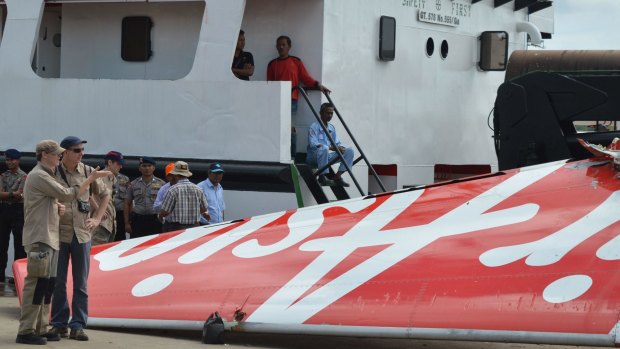 Foreign investigators examine the tail of the AirAsia flight QZ8501 in Kuma.