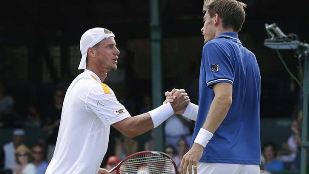 Lleyton Hewitt congratulates Nicolas Mahut after the final of the Hall of Fame Tennis Championships in Newport.