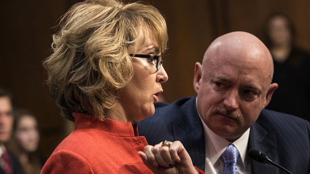 Gabrielle Giffords makes a statement during the Senate Judiciary Committee on Capitol Hill as her husband Mark Kelly looks on.