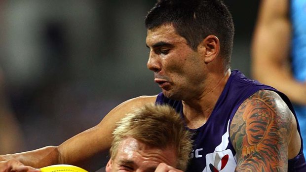 Dennis Armfield of the Blues gets tackled by Clancee Pearce of the Dockers.