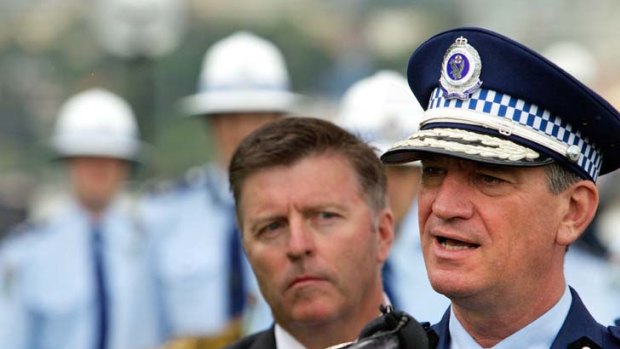 NSW Police Minister Mike Gallacher's (left) office is paying $5 million in compensation to people wrongfully arrested.