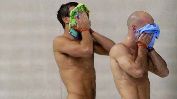 Britain's Tom Daley (left) and Peter Waterfield wipe their faces after a dive in the men's synchronised 10m platform final.