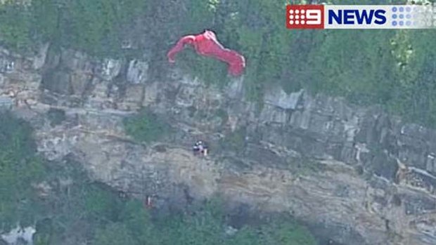Dangling from a cliff: witnesses could hear the paraglider's screams.