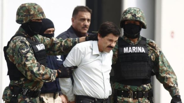 Drug lord Joaquin "Shorty" Guzman  is escorted by Mexican marines in Mexico City on February 22.