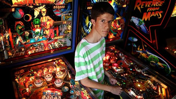 Game time: Nick Dawtrey at home with two of his 10 pinball machines.