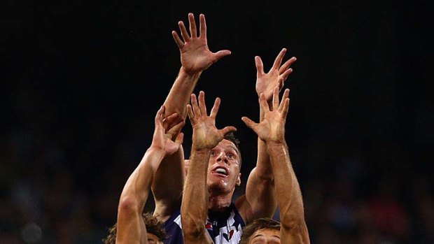Jonathon Griffin and Matt De Boer of the Dockers contest a mark against Ed Curnow and Matthew Kreuzer of the Blues.