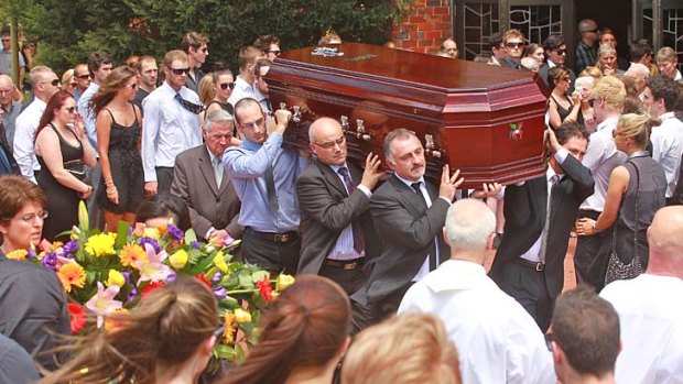 David Cassai's coffin is carried out of the church.