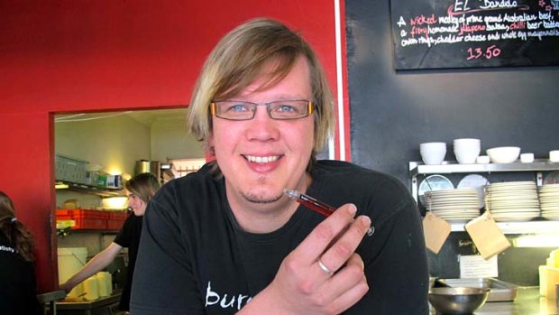 Burger Urge Fortitude Valley co-owner Colby Carthew with the controversial syringe-like pen.