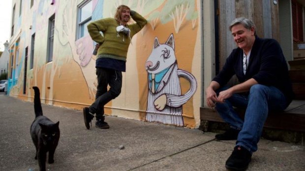 "The more you restrict the freedom of artists to create the imagery they choose, the more you force out the true grittiness of the culture," street artist Birdhat (left) with cafe owner Dale Chaffey.