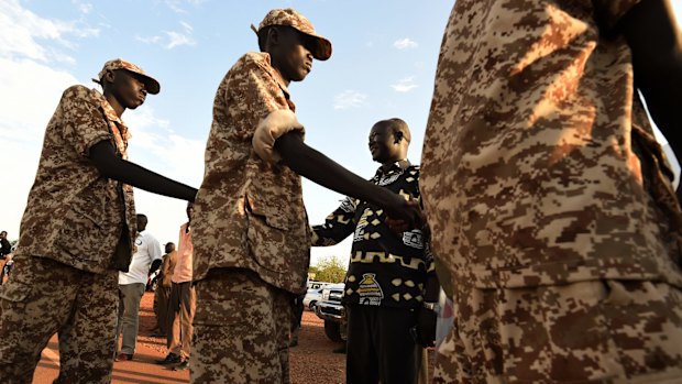 Dobuol Lual, third from left, greets rebel soldiers arriving at Juba airport.