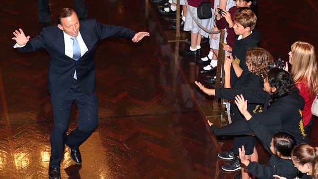 A step to the left: Prime Minister Tony Abbott gives young visitors to the Great Hall an offbeat welcome.