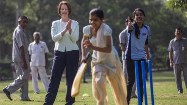 Julia Gillard watches Magic Bus kids play a game of cricket, but refused to play herself, saying she had learnt from John Howard's mistakes.
