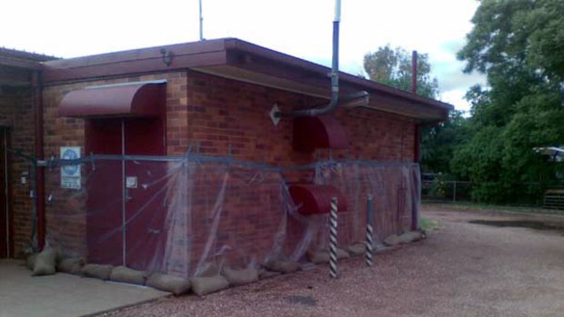 A Telstra St George exchange sandbagged and wrapped in plastic.