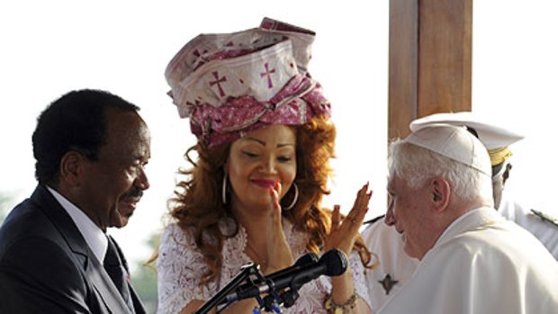 Cameroon President Paul Biya and his wife Chantal, wearing a festive bonnet, welcome Pope Benedict.