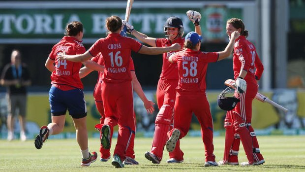 Plenty to cheer about: Charlotte Edwards (centre) is congratulated by her teammates.