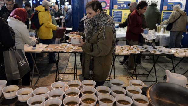 Pensioners get a bowl of hot soup outside the Finance Ministry in Athens last month.