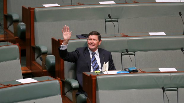 Father of the House Kevin Andrews waves to the public gallery in Parliament House.