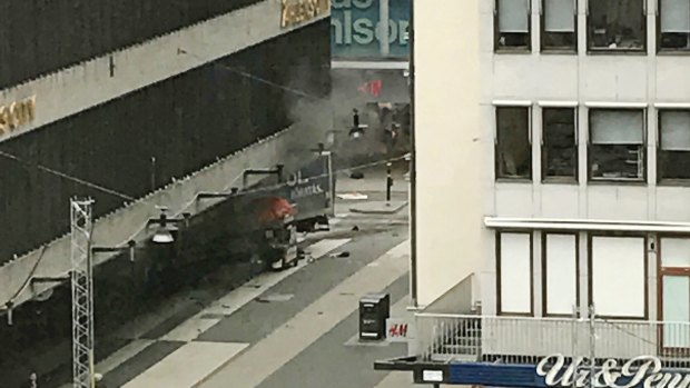 The scene shortly after a truck crashed into a department store in central Stockholm on Friday.