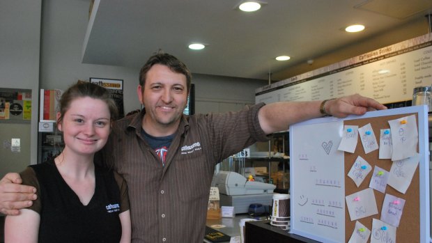 Caffissimo East Perth barista Jessica Goodyer and manager Dean Blackwell with a full Pay-it-Forward board.