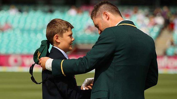 Tom Greig gives his father's handkerchief to Michael Clarke.