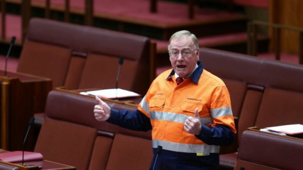 "Disorderly": Liberal Senator Ian Macdonald donned a high-vis “Australians for Coal” provided by the Minerals Council shirt during debate.