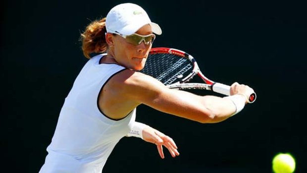 Samantha Stosur plays a backhand during her first round tie against Kaia Kanepi of Spain.