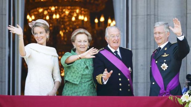 Changing of the guard: King Philippe (right) and Queen Mathilde (left) with King Albert II and Queen Paola on the balcony of the Royal Palace in Brussels.