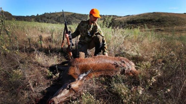 Canberra deer hunter David Carter pictured with a Red Deer shot during an early morning hunt in 2011.