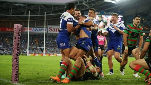 Controversial: The Bulldogs celebrate their hotly contested try against Souths.