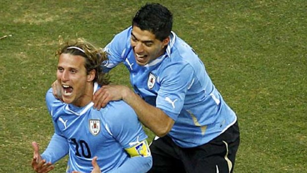 Back of the net ... Diego Forlan, left, celebrates his equalising goal with teammate Luis Suarez.