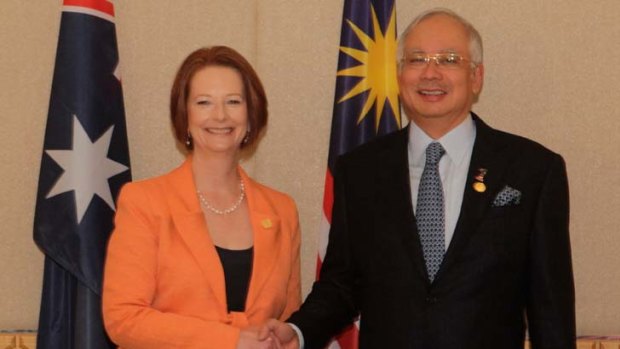 Still firmly committed ... Ms Gillard and Mr Najib at CHOGM yesterday.
