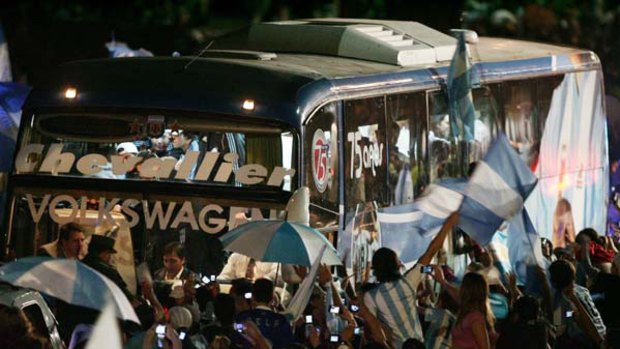 Argentine national team supporters surround the bus which brings the players upon their arrival at Ezeiza airport in Buenos Aires.