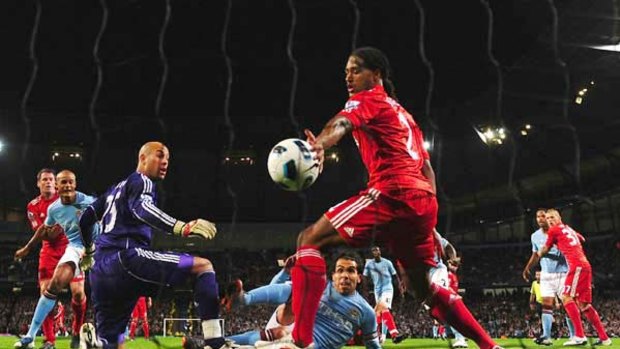 Carlos Tevez scores Manchester City's second goal.