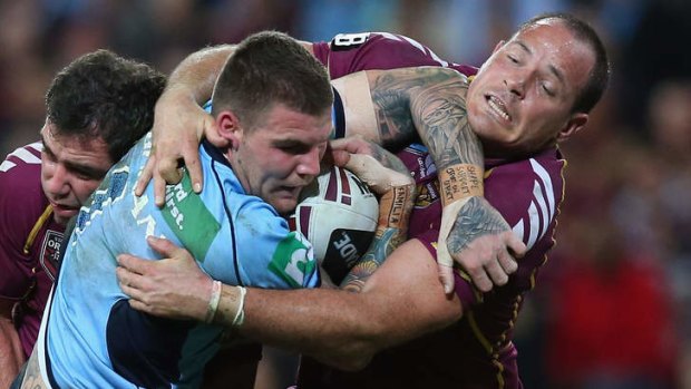 Josh Dugan is tackled by Maroons Cameron Smith and Matthew Scott during game two of  Origin at Suncorp Stadium.