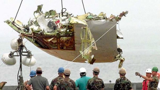 US  Army National Guard soldiers look on as the cockpit from TWA Flight 800 is recovered at Hampton Bays, New York,  in 1996.  All 230 people aboard the Paris-bound 747 died when the jet exploded shortly after take-off.