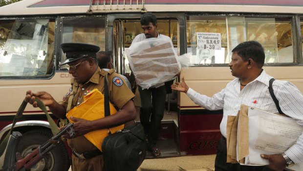 A Sri Lankan poll official unloads a ballot box from a bus at a counting centre in Jaffna.