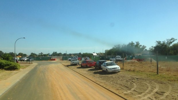 Houses, roads and pathways are coated in dust and dirt by trucks entering and exiting Gateway WA project to upgrade commuter routes near the airport.