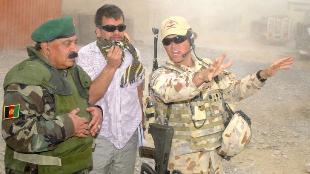 ADF Major Paul Foura (right) shows Afghan National Army Brigadier General, Gul Aqa Naibi around Forward Operating Base Locke in Afghanistan.