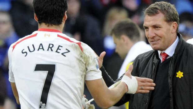 Reds alert: Liverpool manager Brendan Rodgers (right) congratulates Luis Suarez after the striker's hat-trick last weekend