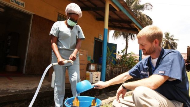 Dr. Kent Brantly, one of the two Americans who contracted Ebola, works at an Ebola isolation ward at a mission hospital outside of Monrovia, Liberia before contracting the virus.