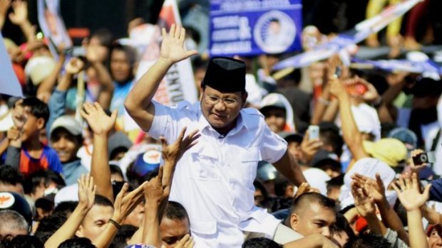Dogged by a controversial past: Indonesian presidential candidate Prabowo Subianto gestures to supporters during a campaign at Andi Mattalata stadium in Makasar this week.
