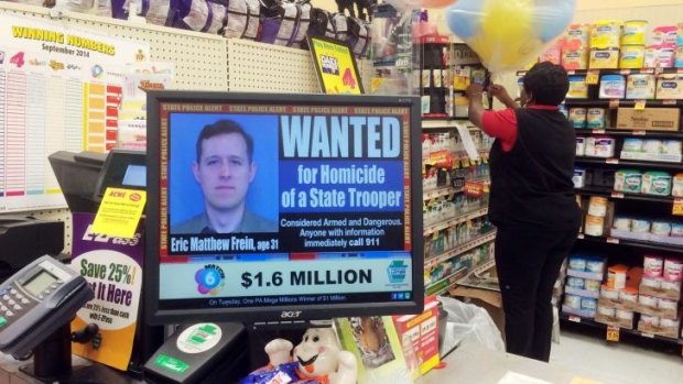 Displayed at a grocery store is a wanted advertisement for murder suspect Eric Frein.