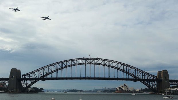 A Qantas Airbus A380 and Emirates Airbus A380 fly over Sydney Harbour on Sunday, marking a new partnership.