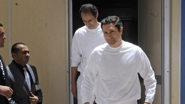The two sons of former president Hosni Mubarak, Gamal, left, and Alaa Mubarak arrive at the police academy courthouse in Cairo in 2012. 