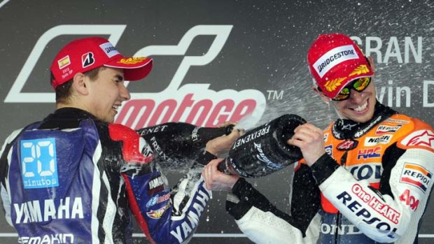 Casey Stoner and  Jorge Lorenzo celebrate on the podium after the Spanish Grand Prix.