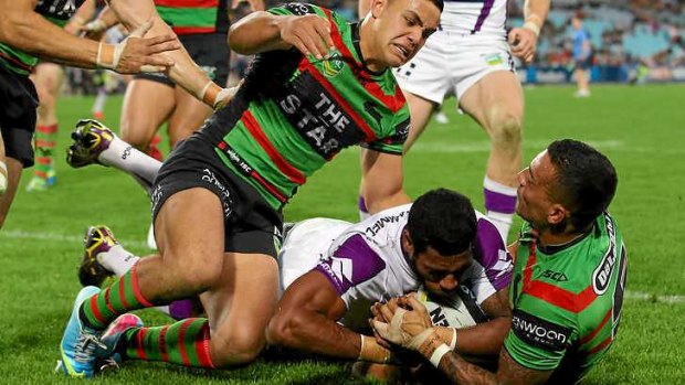 Try or no try: Sisa Waqa of the Storm is held up over the line by the Rabbitohs.