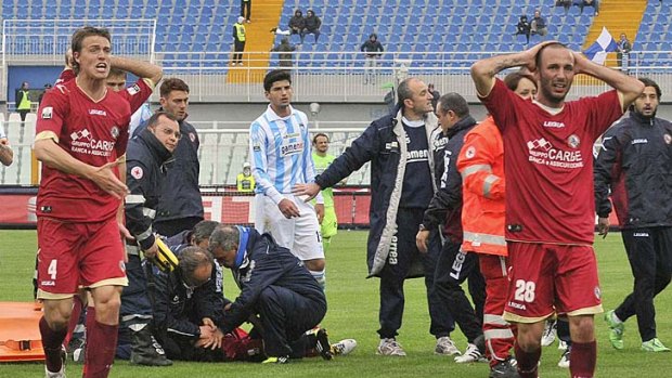 Anguish ... Piermario Morosini's teammates react as he is treated on the pitch.