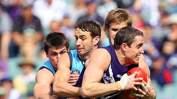 Swamped: Carlton players wrap up Fremantle's Luke McPharlin in the Dockers' 30-point loss at home.