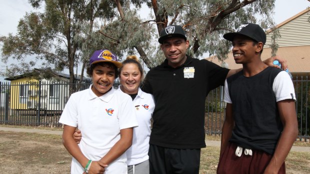 SMH News. Story Julie Power. Walgett NSW. Story on problems at Walgetts only  public High School. Photo shows, Former Souths player, Nathan Merritt pictured with students from Walgett High School, as part of Lets Tackle Domestic Violence tour of outback towns. Photo: Peter Rae Tuesday 26 May, 2015.