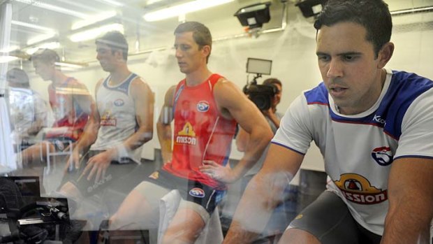 Along for the ride: Brett Goodes joins teammates on the bikes.